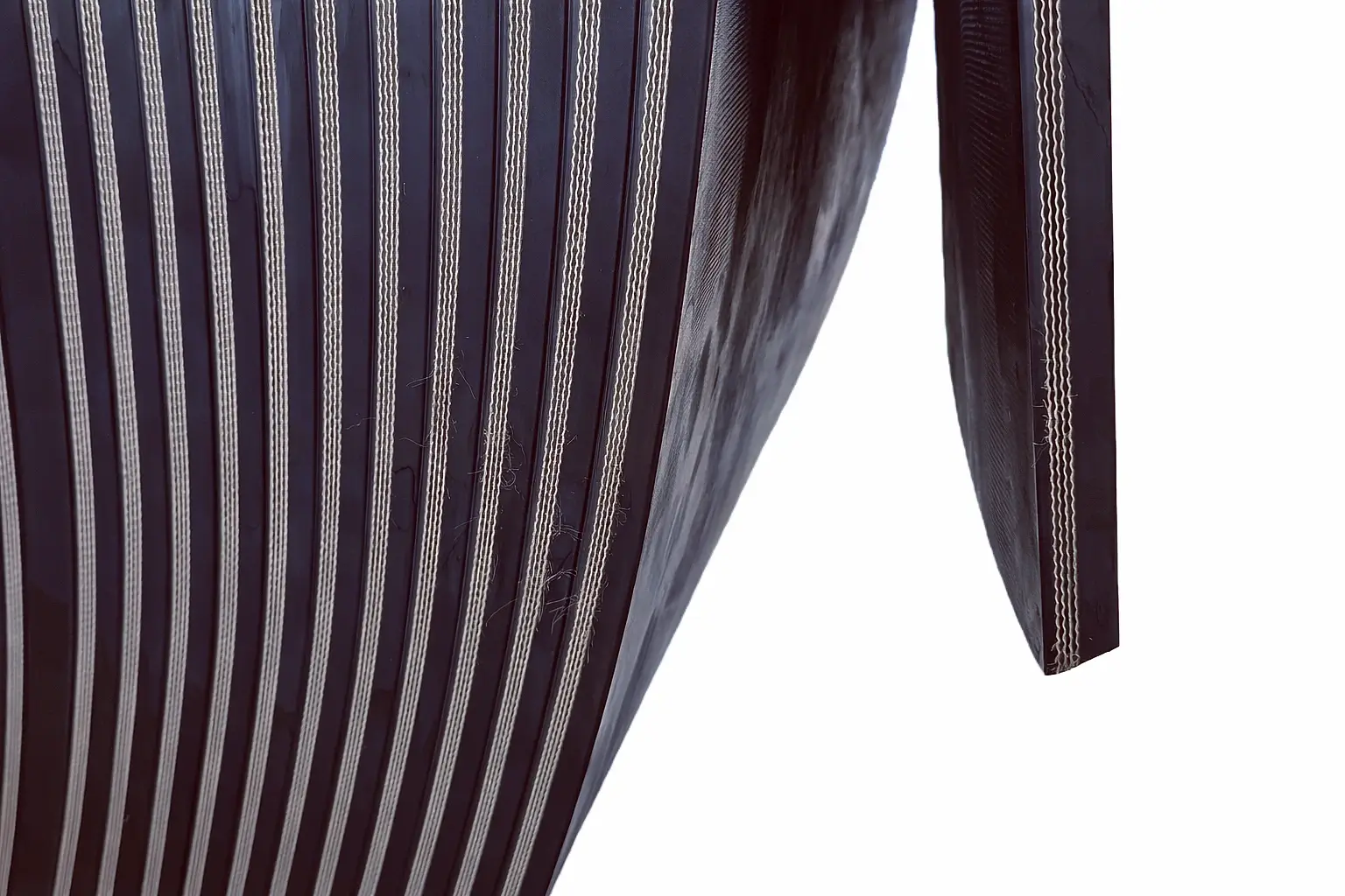 Cut edge fabric rubber conveyor belt showing exposed textile reinforcement layers