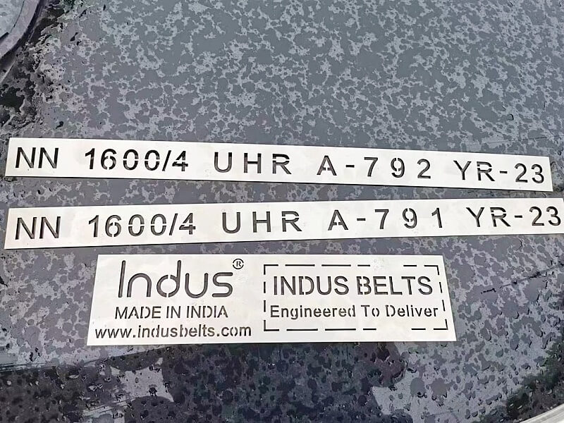 INDUS OEM logo and belt specification markings on rubber conveyor belt