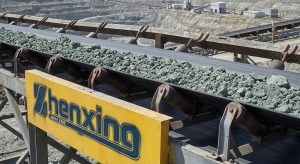Rubber conveyor belt transporting ore in open-pit mining application