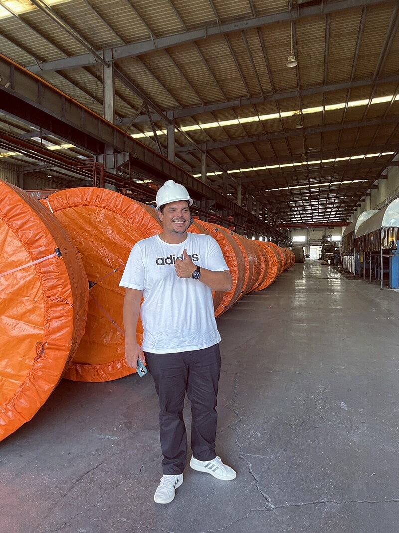Brazil customer visiting conveyor belt factory and inspecting finished belt rolls