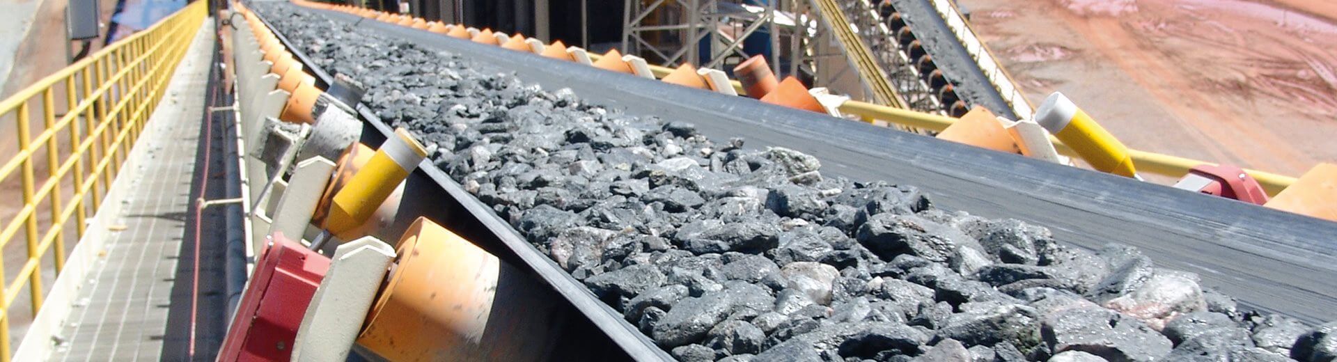 Fabric conveyor belt transporting bulk materials in mining and aggregate handling application