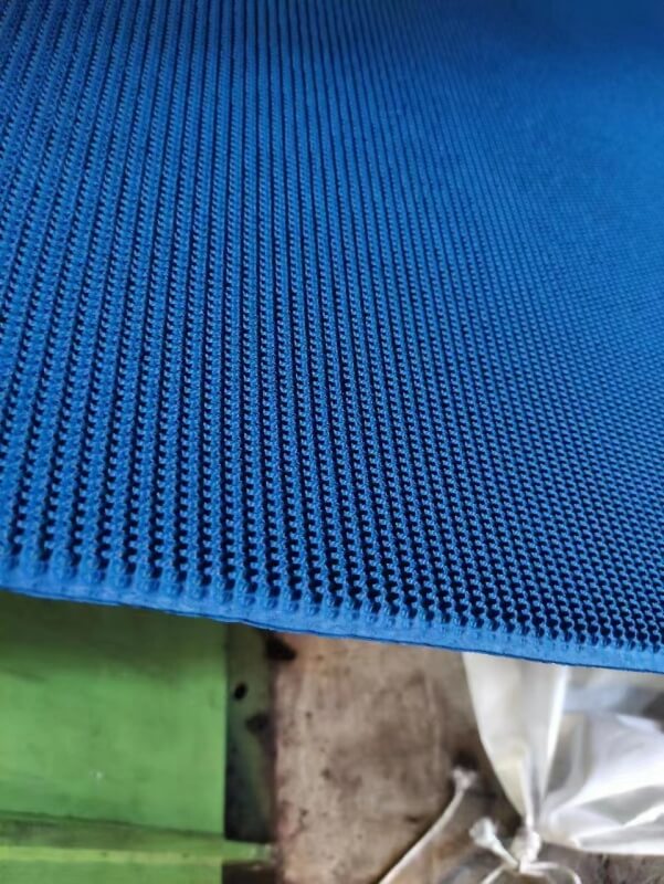 Blue rough top conveyor belt textured anti-slip surface close-up