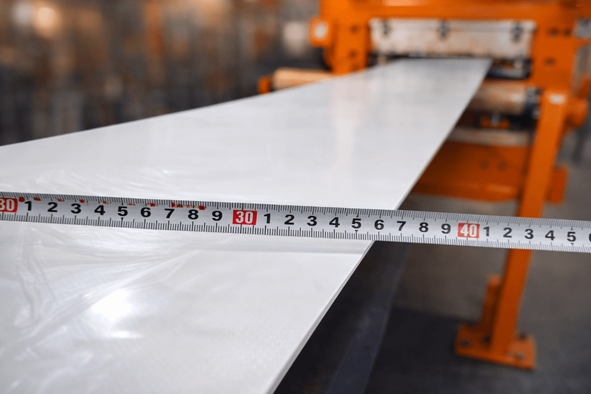 Custom width white conveyor belt measured during production in factory