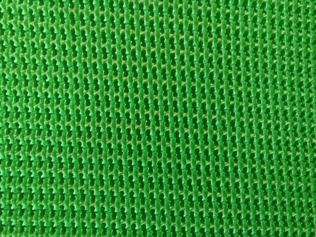 Green rough top conveyor belt textured anti-slip surface close-up