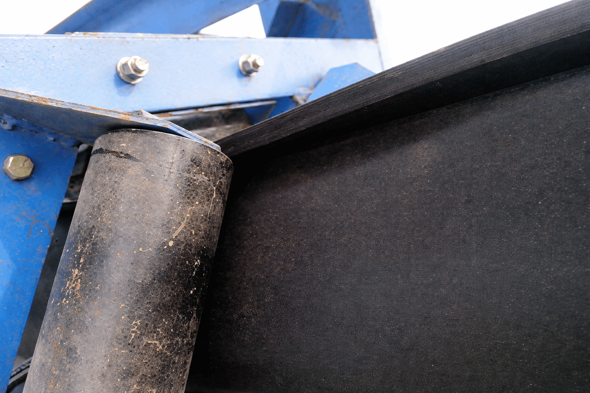 Pipe conveyor belt contact area with idler roller showing rubber surface wear resistance and smooth running condition