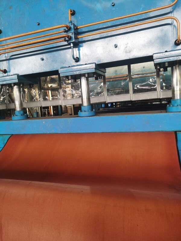 Rough top conveyor belt production on vulcanization press line in factory