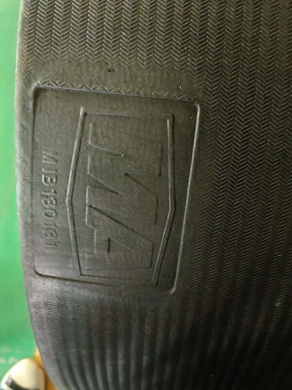 Solid Woven PVC PVG conveyor belt surface with anti-slip herringbone texture and embossed mining grade marking for underground coal applications