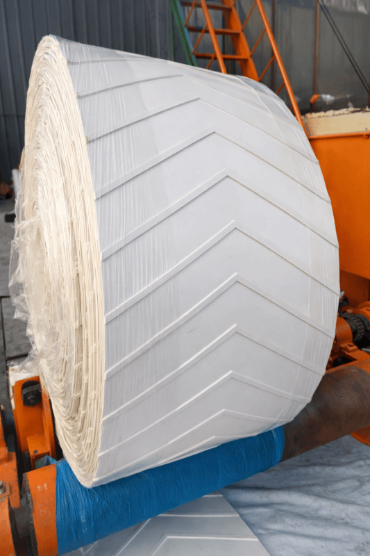 White chevron conveyor belt roll with anti-slip V pattern surface