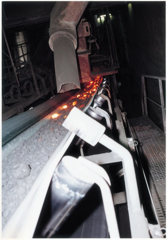 heat resistant rubber conveyor belt transporting hot material in high temperature industrial processing plant