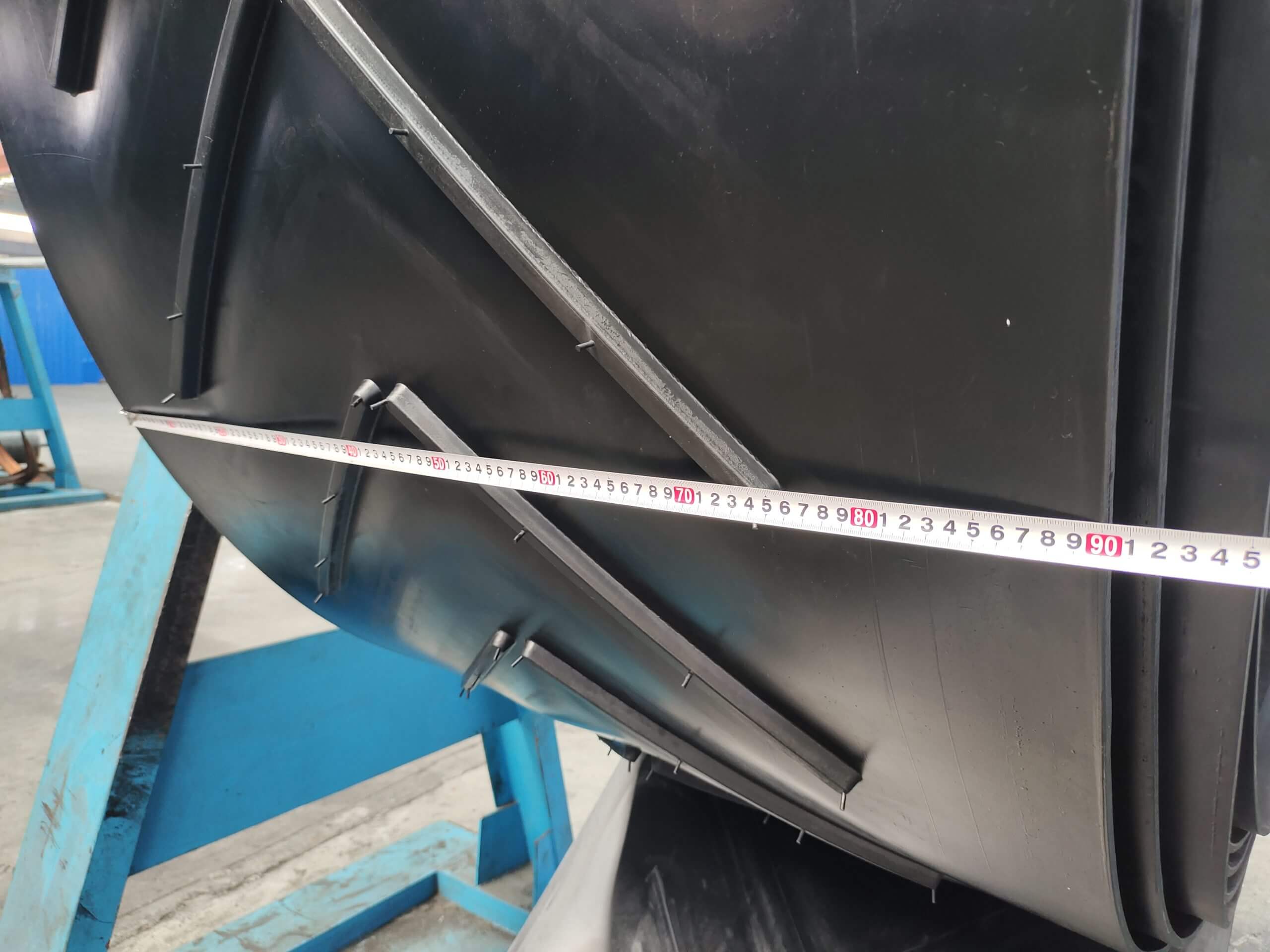 Chevron conveyor belt V pattern cleat height measurement close-up